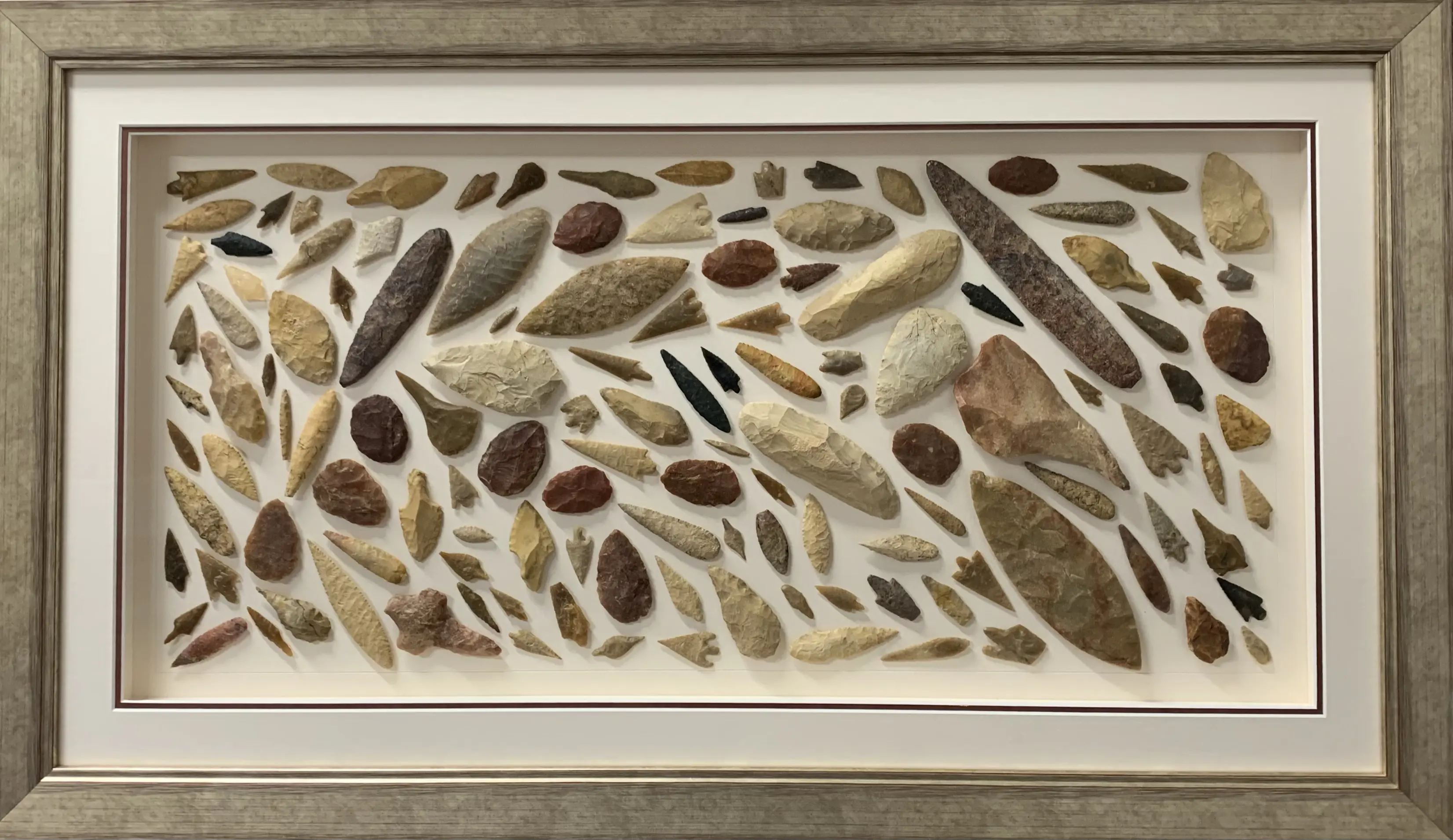 Framed arrowhead and stone collection