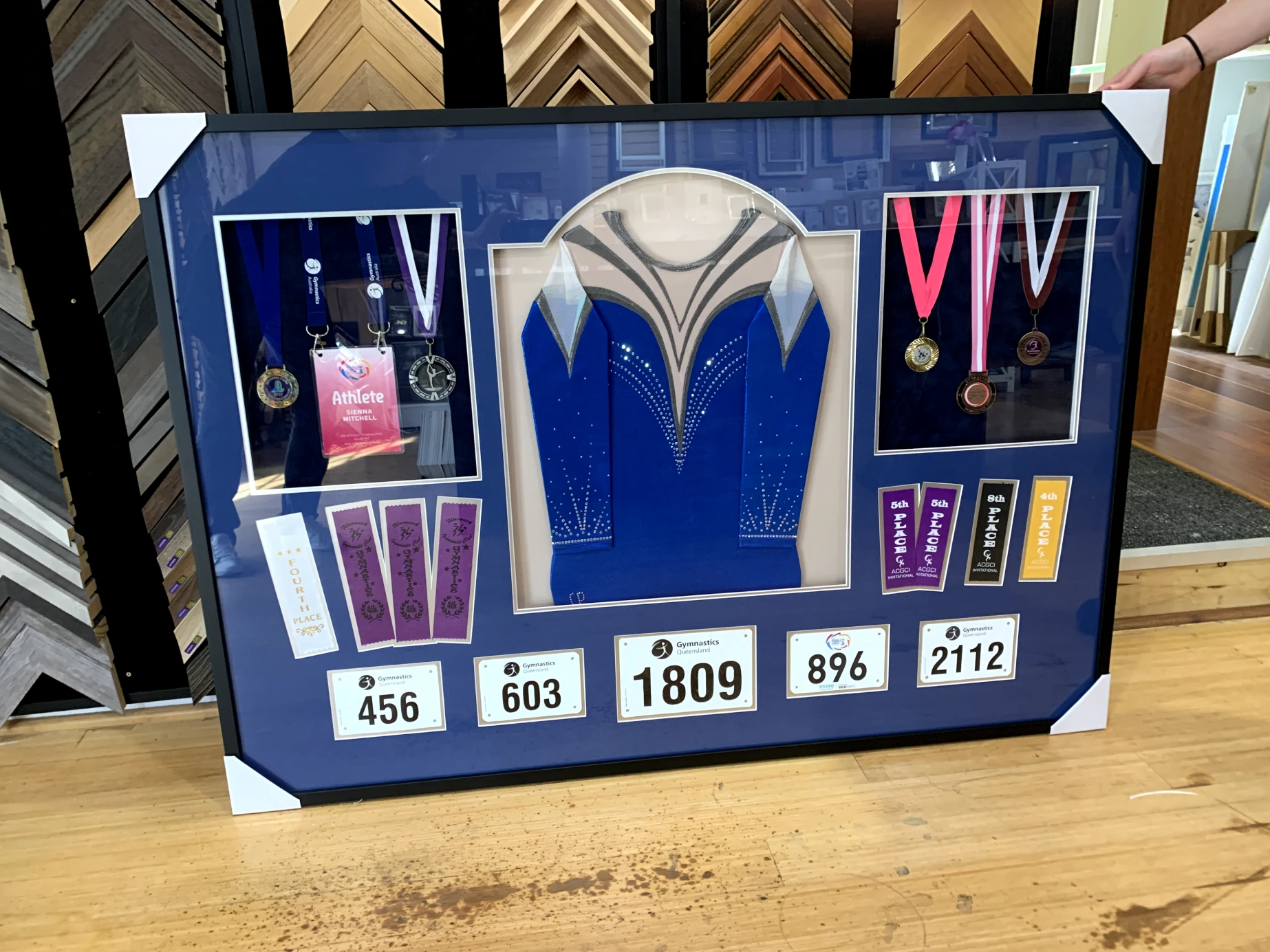 Gymnastics frame with multiple cutouts for medals